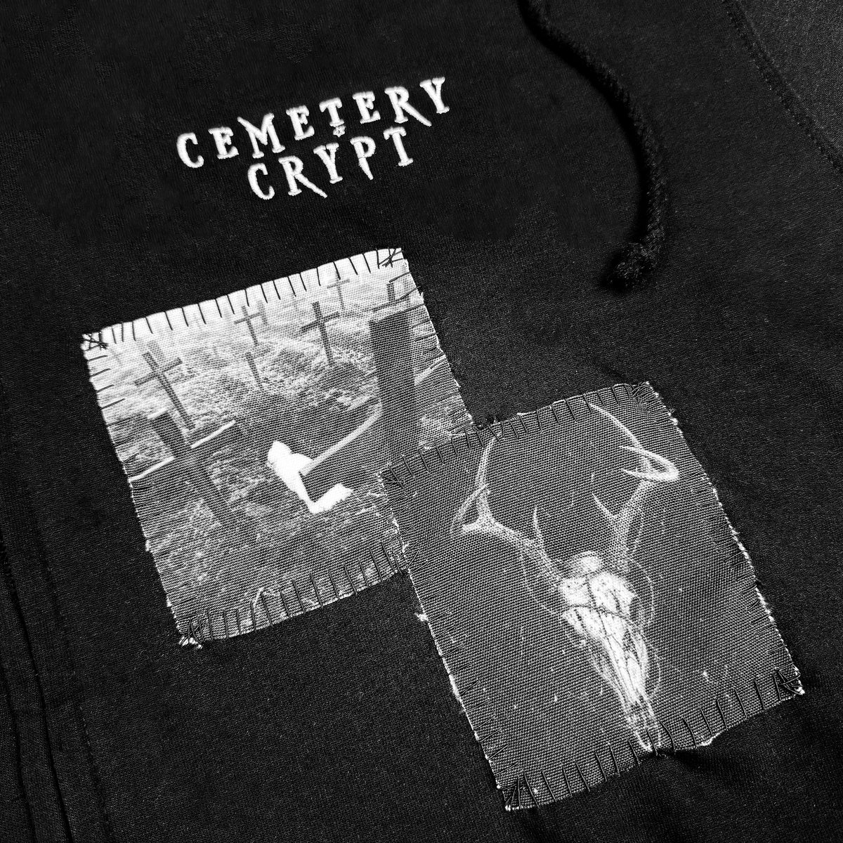 Close-up of patches and embroidered logo on Vulture Patched Zipper Hoodie