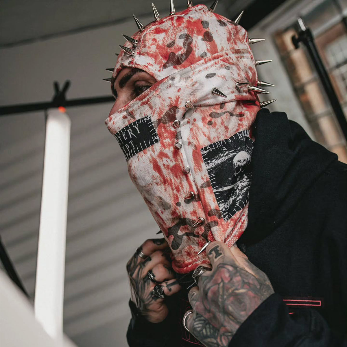 Model wearing the Bloody Snow Spiked Balaclava in profile with a hand beneath the chin