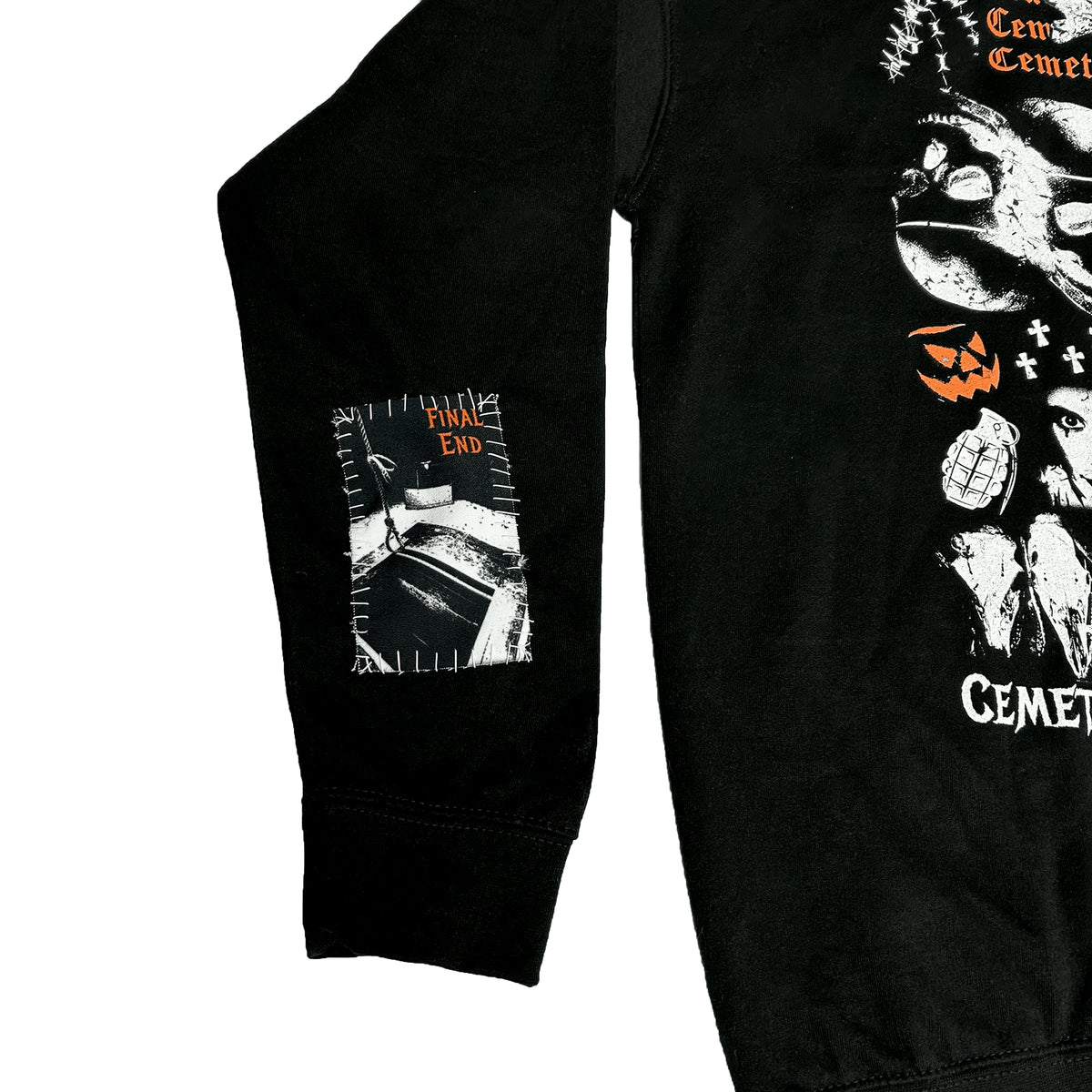Close-up of the Catacombs Hoodie sleeve showing a monochrome hospital bed print and small orange lettering