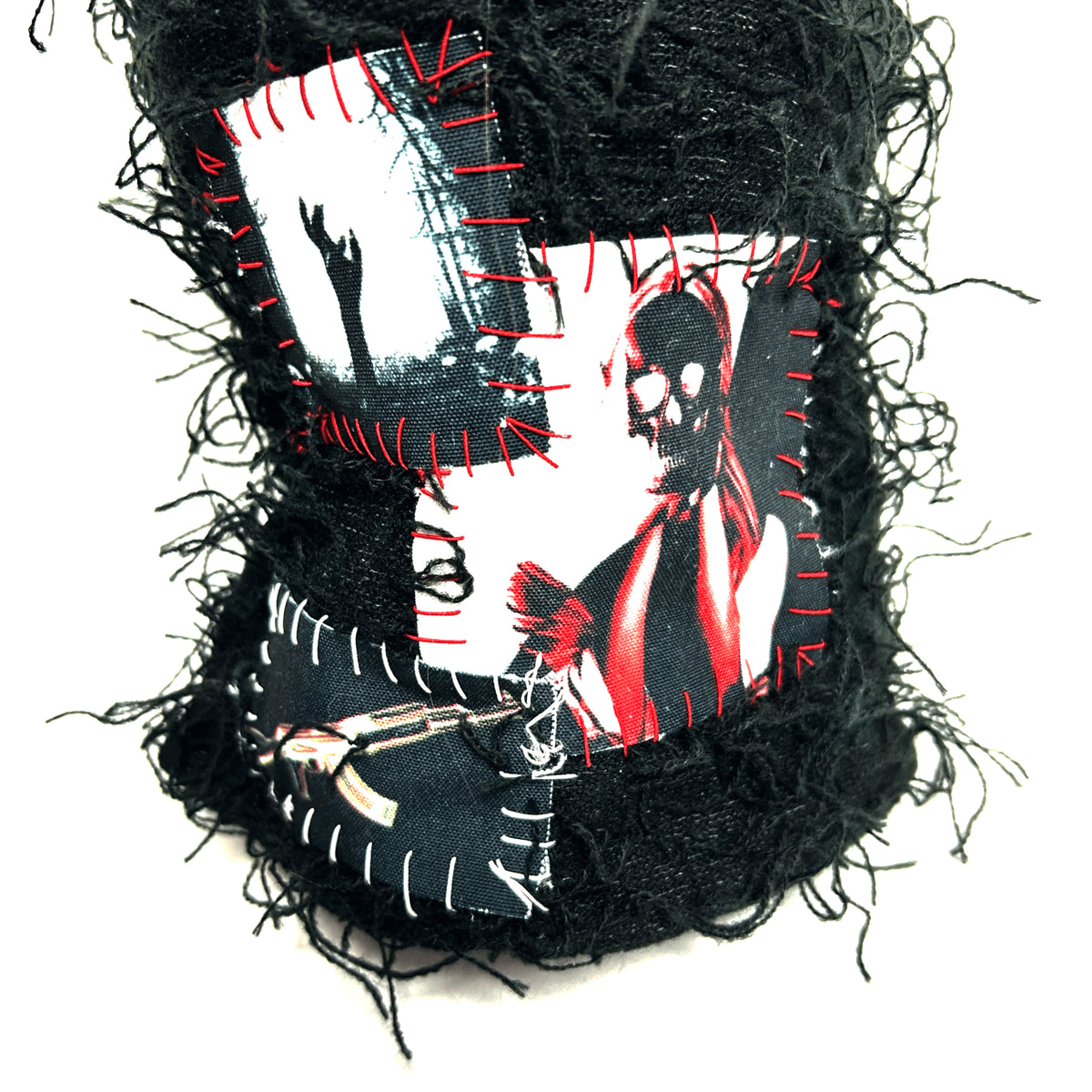 Close-up of red-and-white graphic patches and contrasting stitches on the front of the Cemetery Balaclava