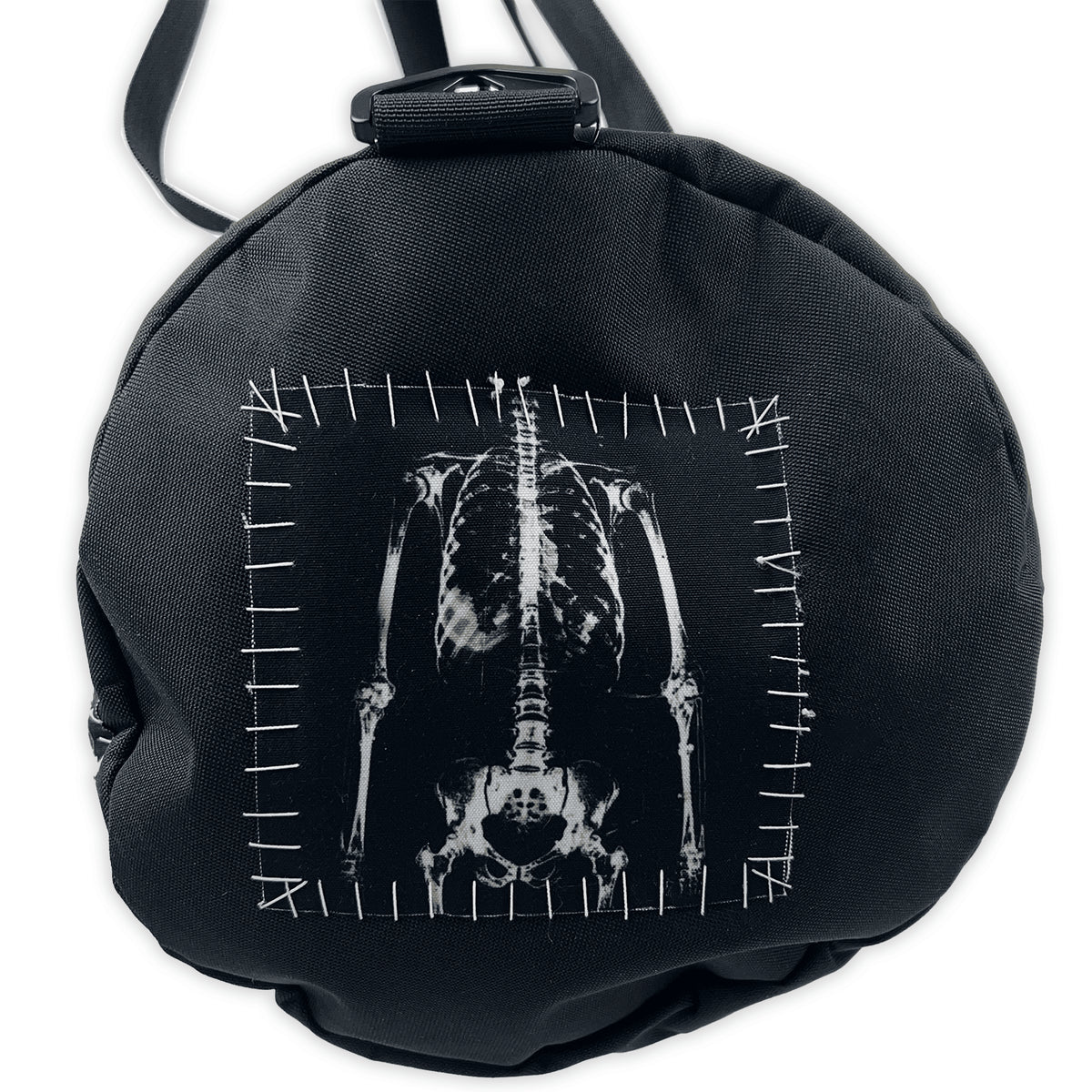 Round end of the Corpse Barrel Bag XL with a white skeleton patch and contrasting stitched border