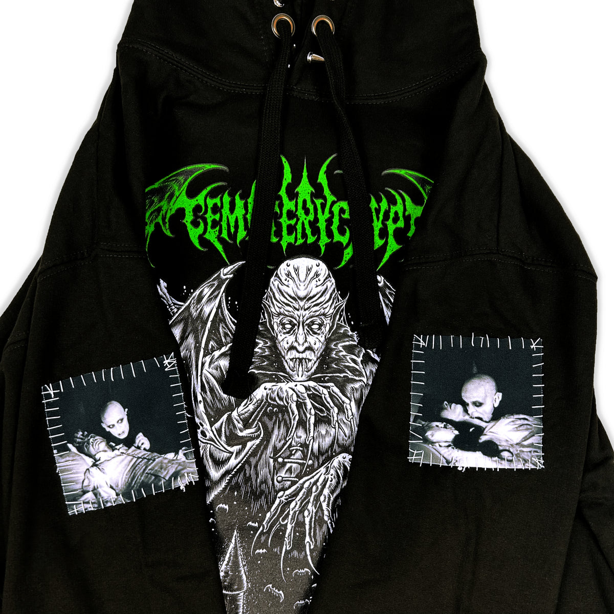 Close-up of the Dracula Hoodie front showing the white vampire portrait, green lettering and smaller side graphics