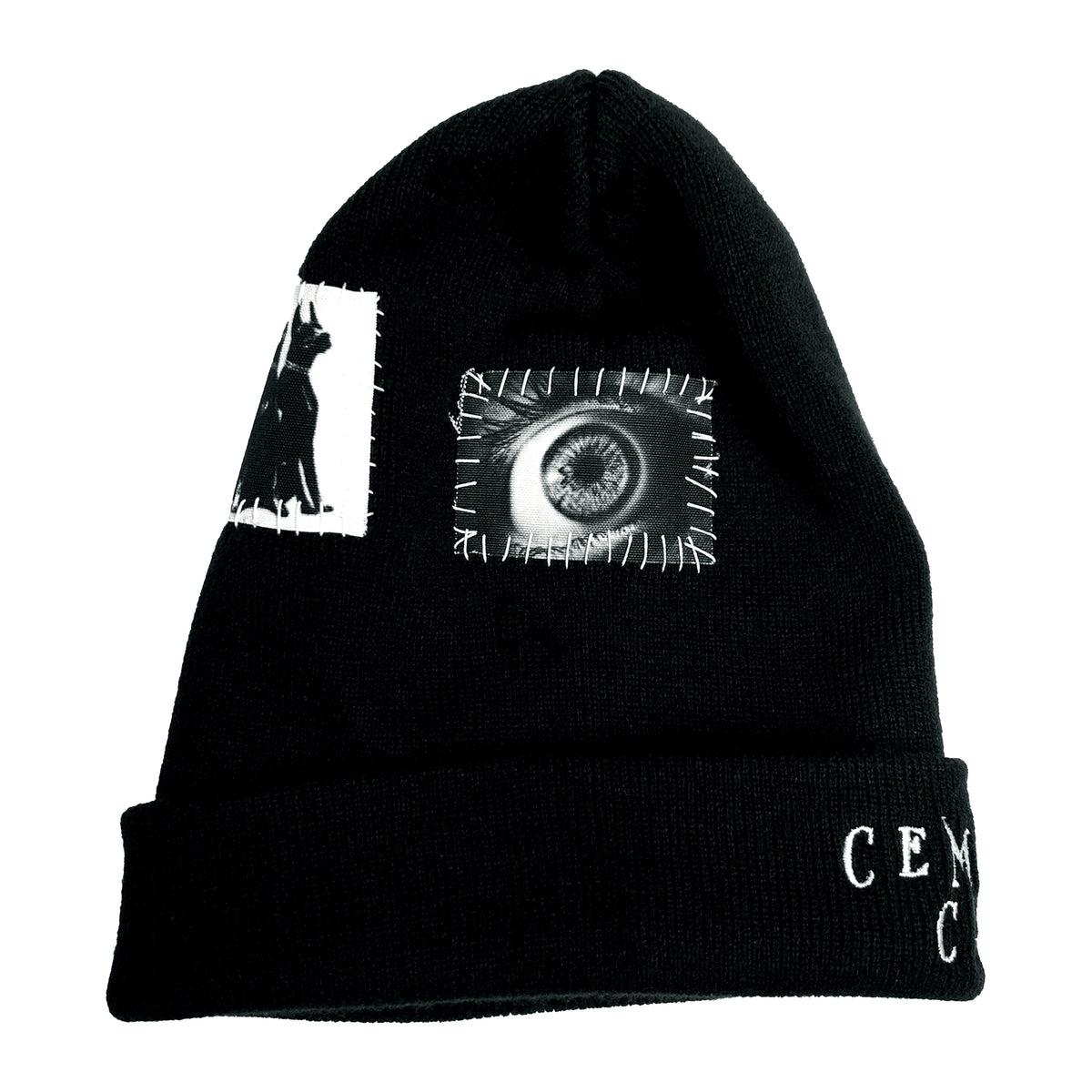 Side of the black Grave Patched Beanie showing a white eye graphic patch with contrast stitching