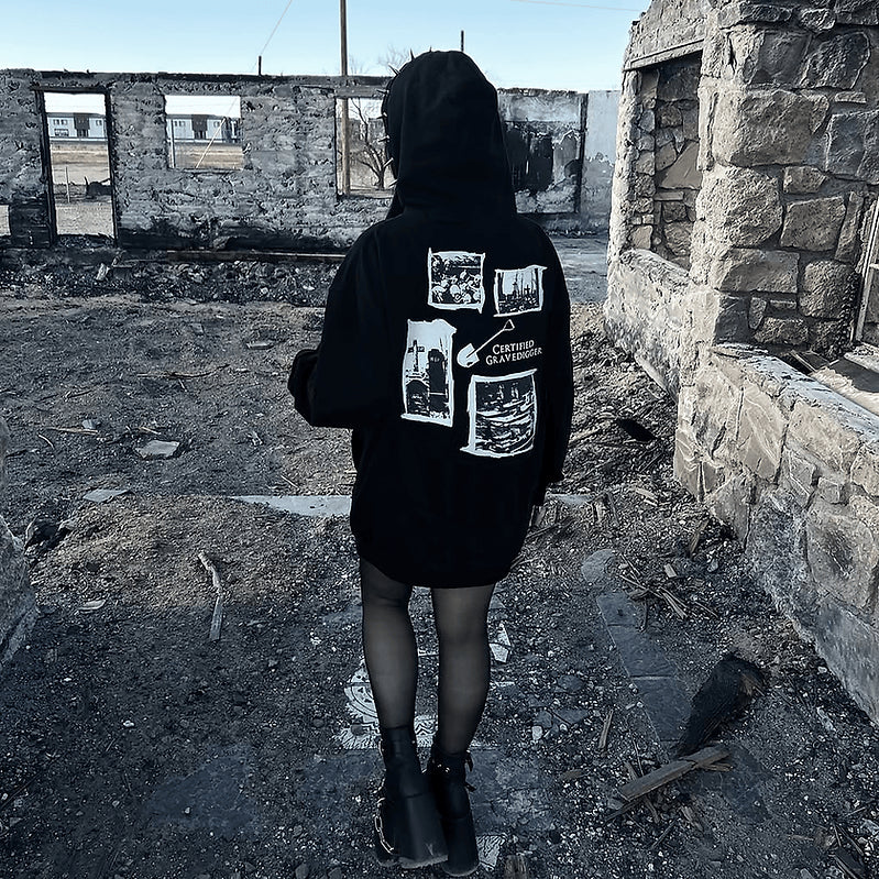 Rear view of a model wearing the Gravedigger Hoodie, showing the large white graveyard collage