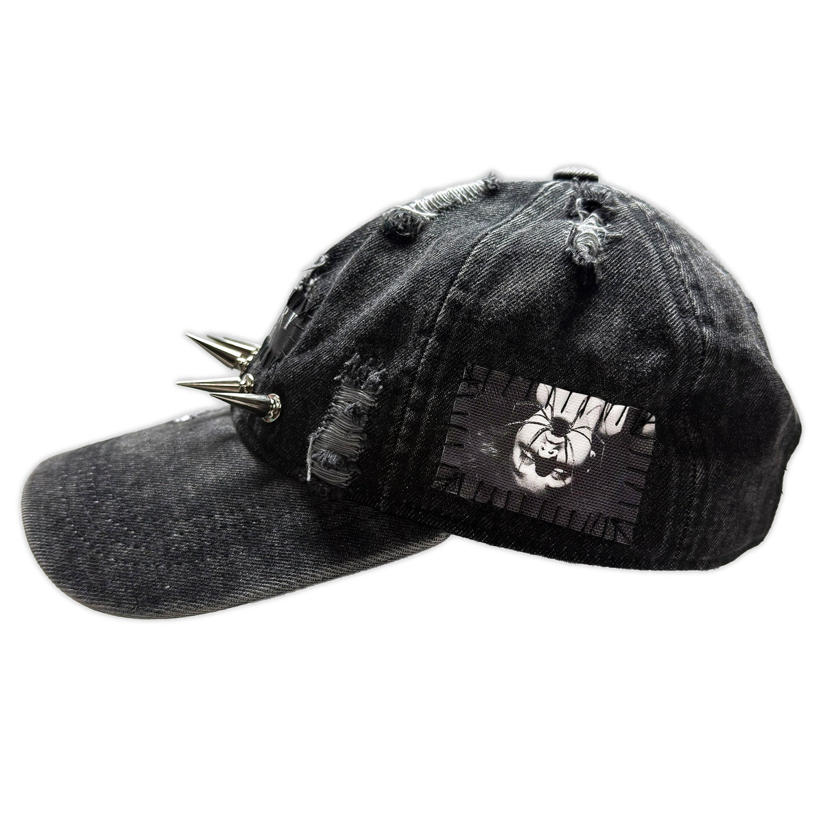 Side of the grey Parasite Denim Cap with a monochrome face patch, distressed fabric and silver brim spikes