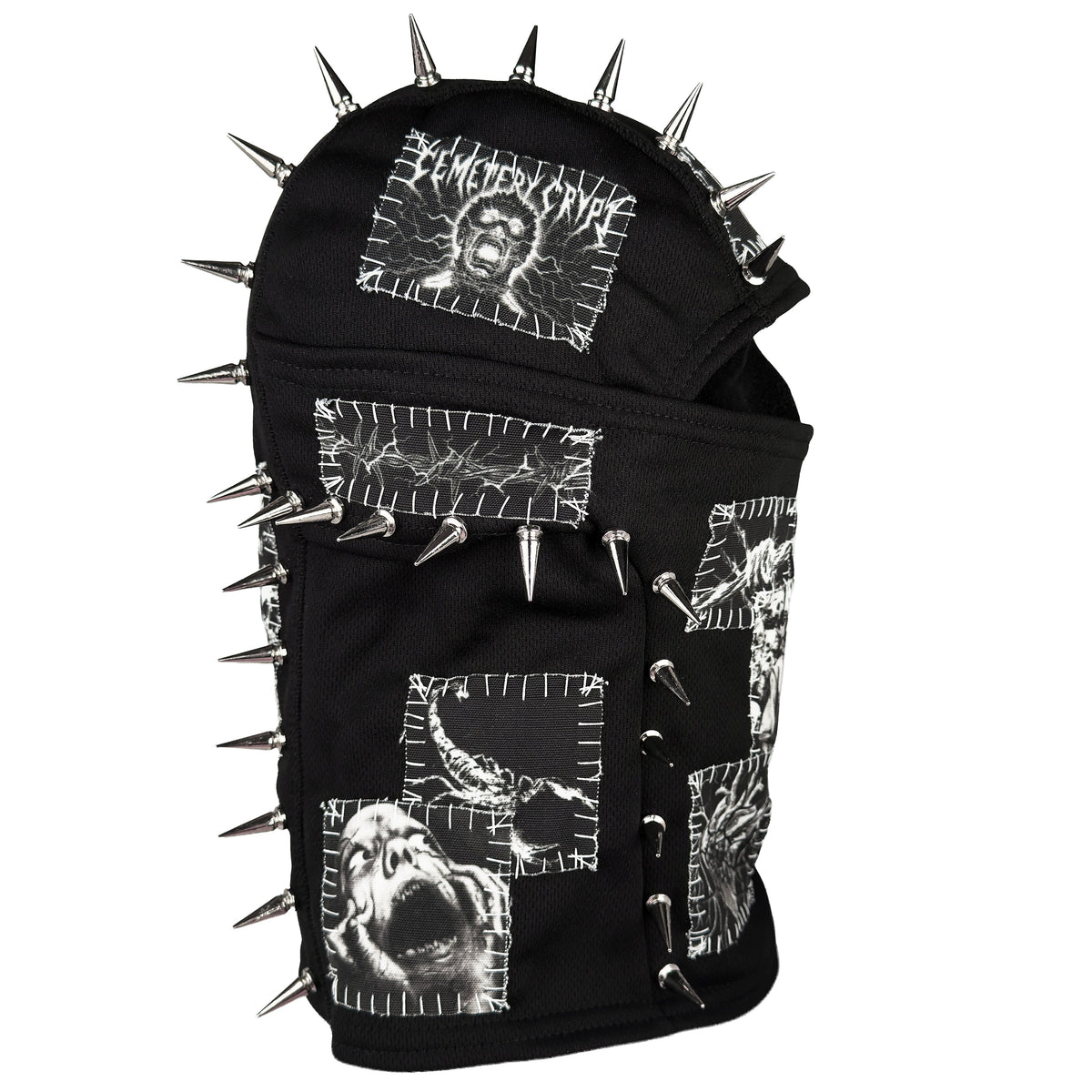 Angled side of the Patched Balaclava V2 showing an eye patch, white graphic panels and silver spikes