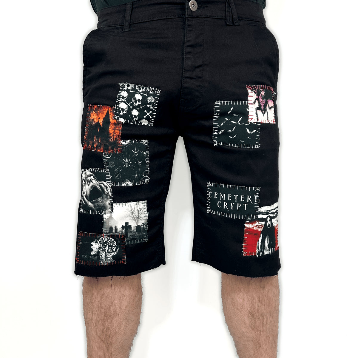 Model wearing the Ripper Denim Shorts from the front, showing the graphic patches and knee-length cut