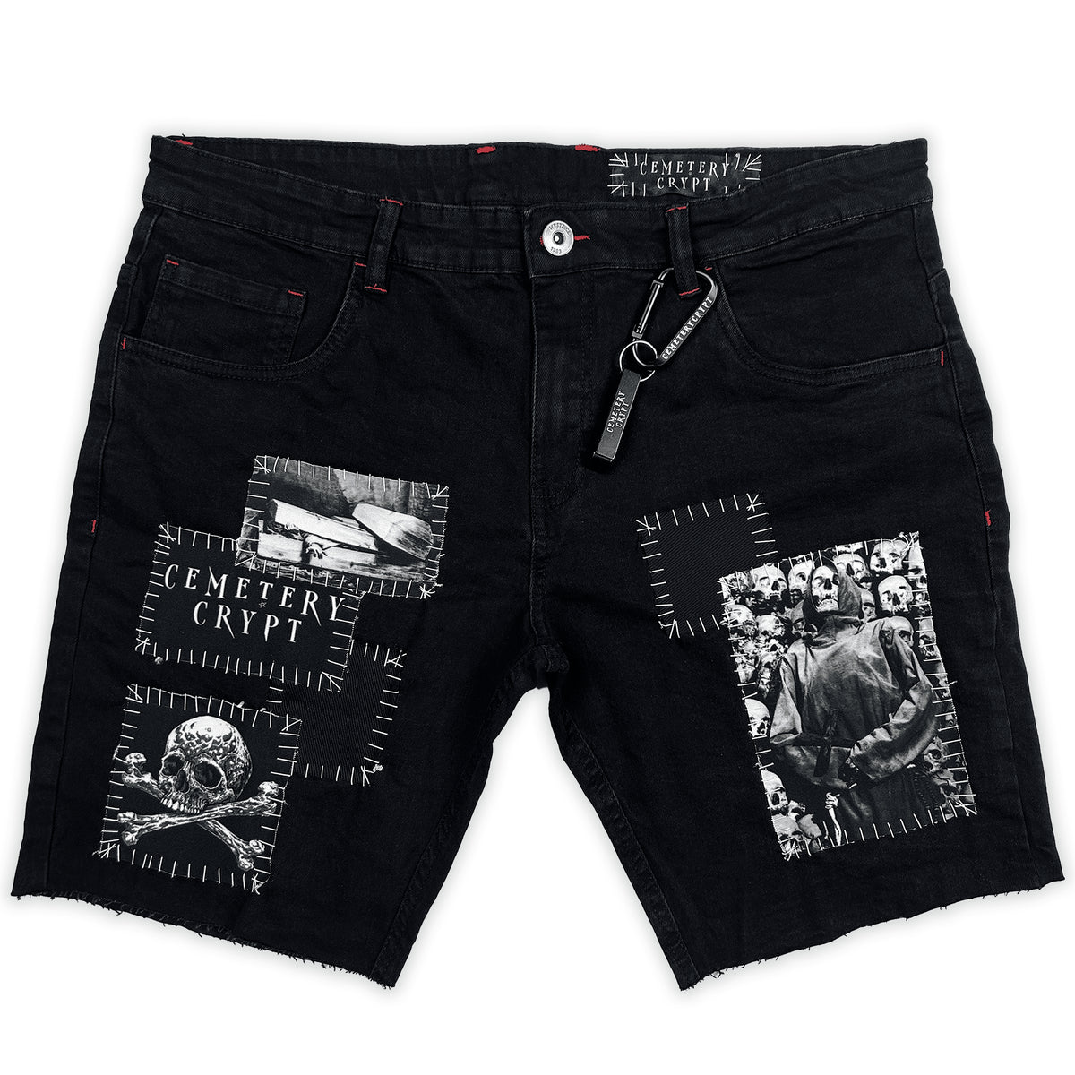 Front of the black Rotten Denim Shorts with monochrome graphic patches, white stitching and a metal waist clip