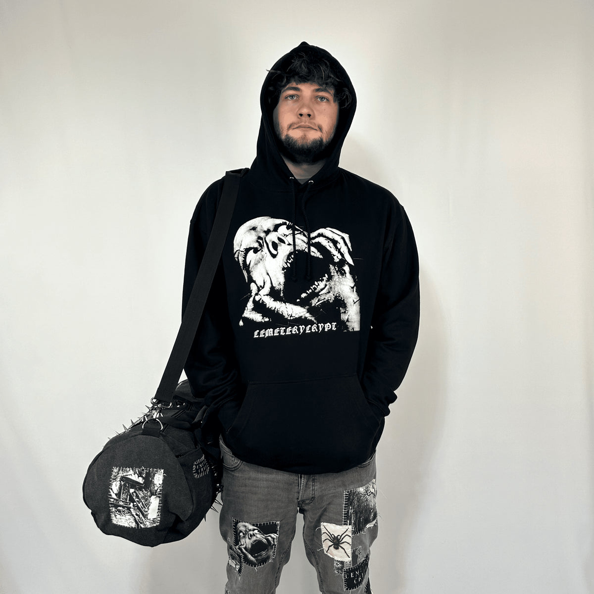 Model holding the Terror Barrel Bag by its handles, showing the bag size and printed round end