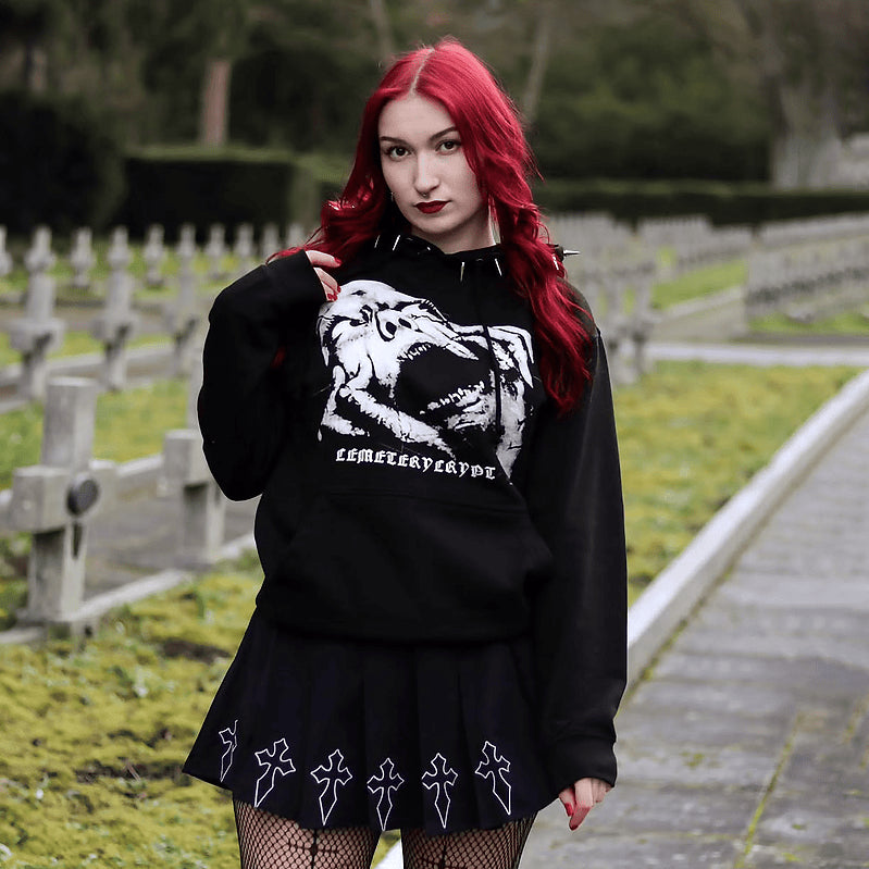 Model wearing the black Terror Hoodie among gravestones, showing the large white front print
