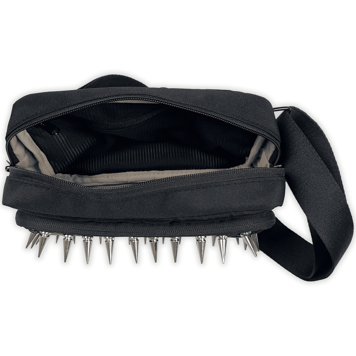 Top view into the zipped main compartment of the Tombstone Crossbody Bag, with spikes along the front